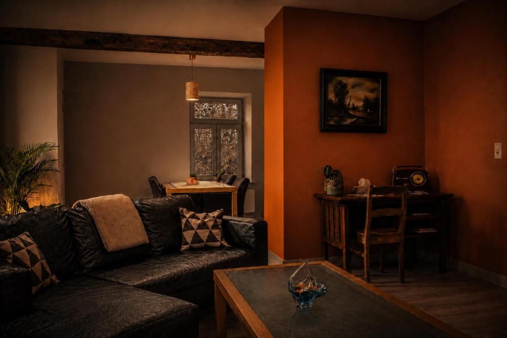 a living room with a couch and a table at Hoeve Verdre - De Knechtenwoning in Heers