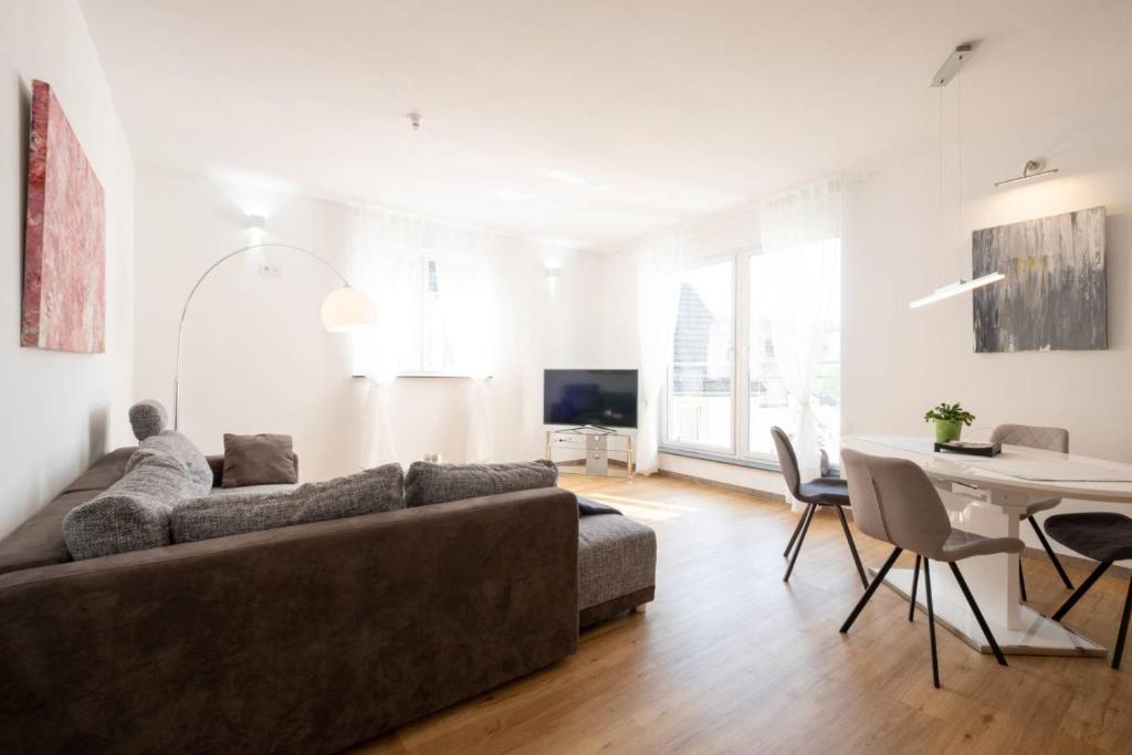 a living room with a couch and a table at eifel5starIV Burgfriedstraße in Daun