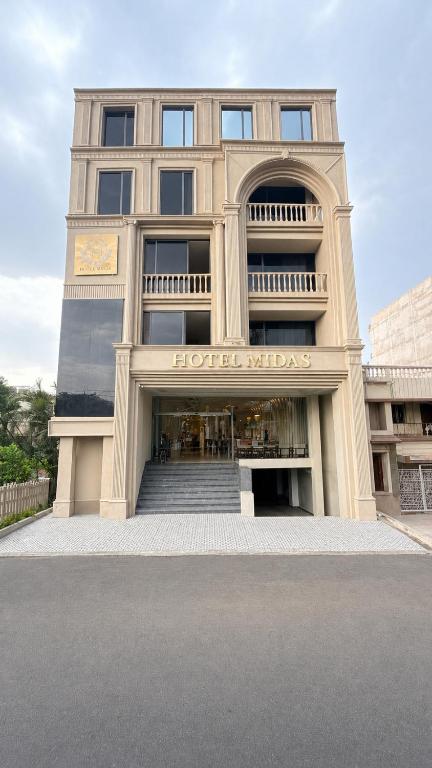 a large building with a hotel insignia on it at hotel midas in Sāgar