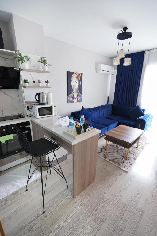 a living room with a blue couch and a table at Classic Suite MK1 in Istanbul
