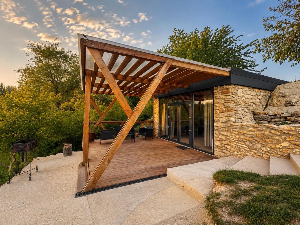 a house with a wooden deck with a roof at Terra House in Andrushovka