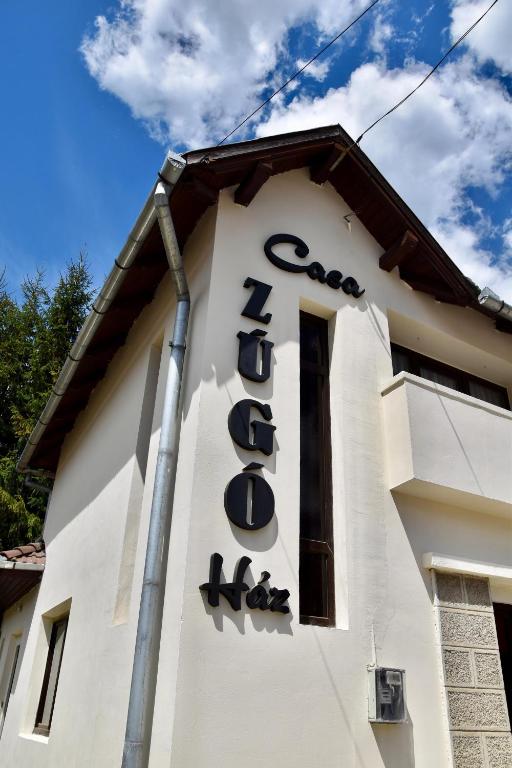 a sign on the side of a building at Casa ZUGO in Borsec