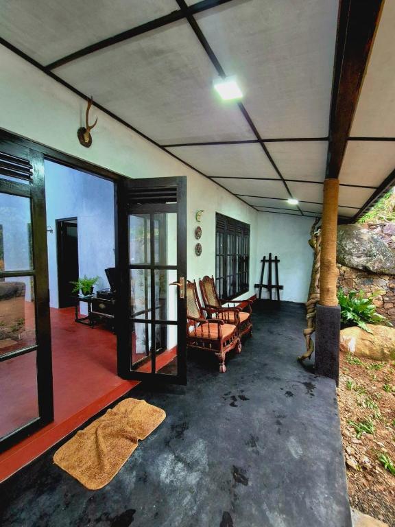 a living room with a couch and chairs at Sampath State in Koslanda