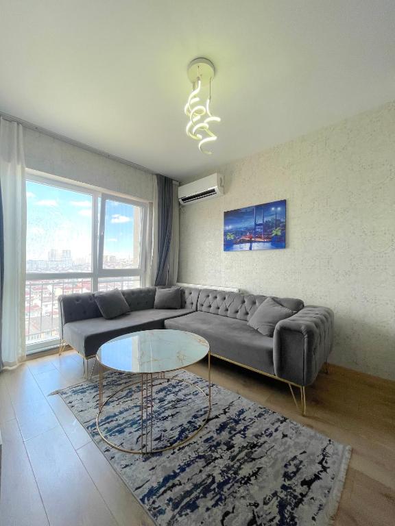 a living room with a couch and a glass table at Classic Suite BH13 in Esenyurt