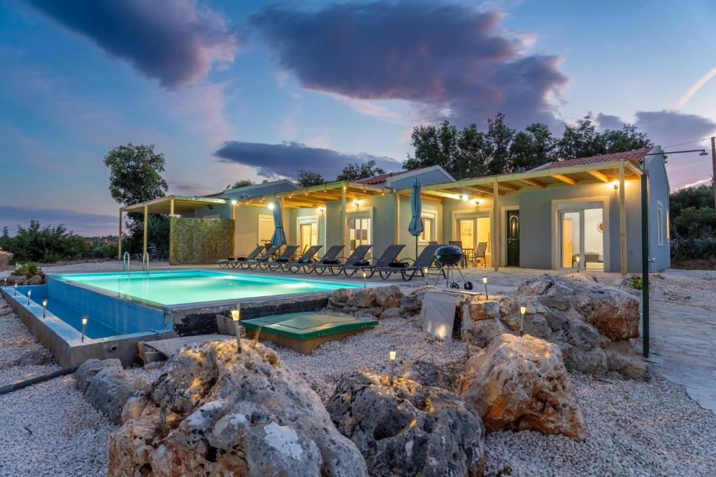a villa with a swimming pool in the desert at Studios Maximo in Karavádhos