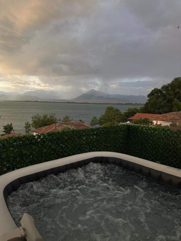 a hot tub with a view of the water at Shiroke Relax Villa in Shirokë