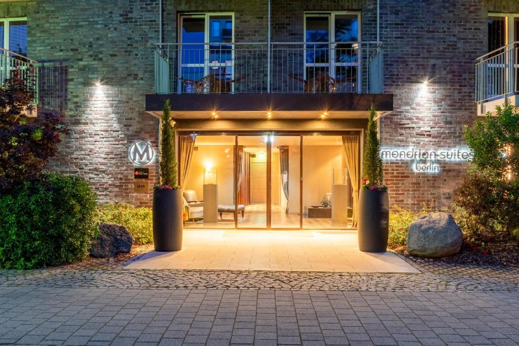 an entrance to a brick building with lights on it at Mondrian Suites Berlin am Checkpoint Charlie in Berlin