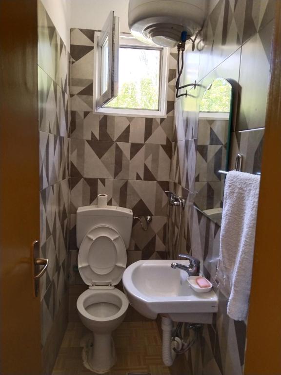 a bathroom with a toilet and a sink at Ogi in Straševina