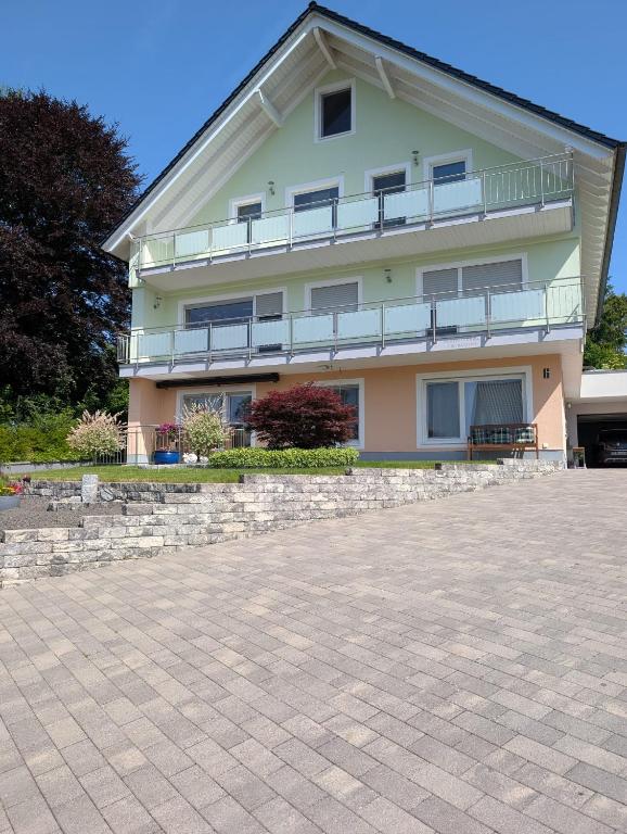a large apartment building with a large patio at Ferienwohnung zum Bätstän in Pluwig