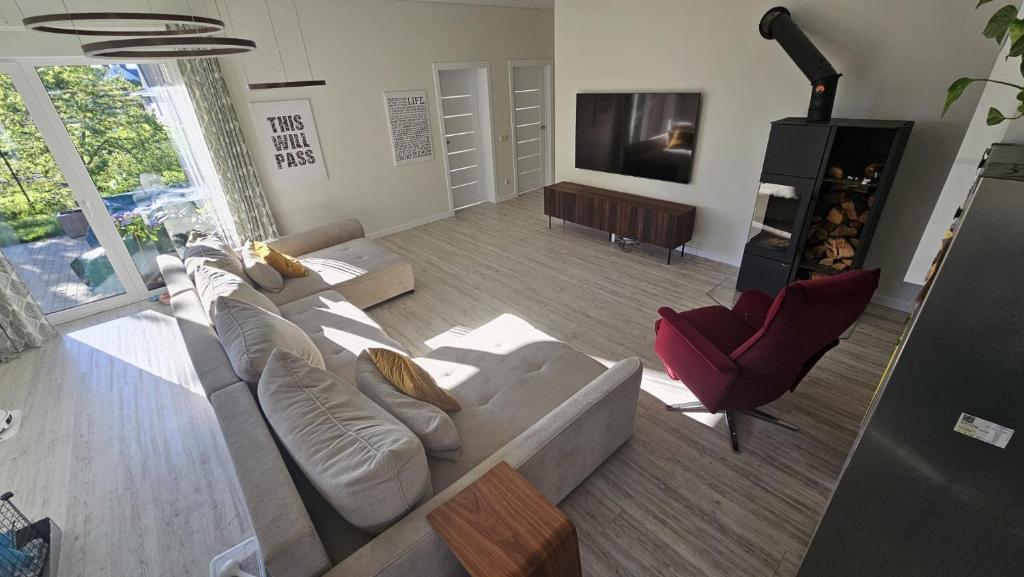 a living room with a couch and a tv at Pavilnis house in Vilnius