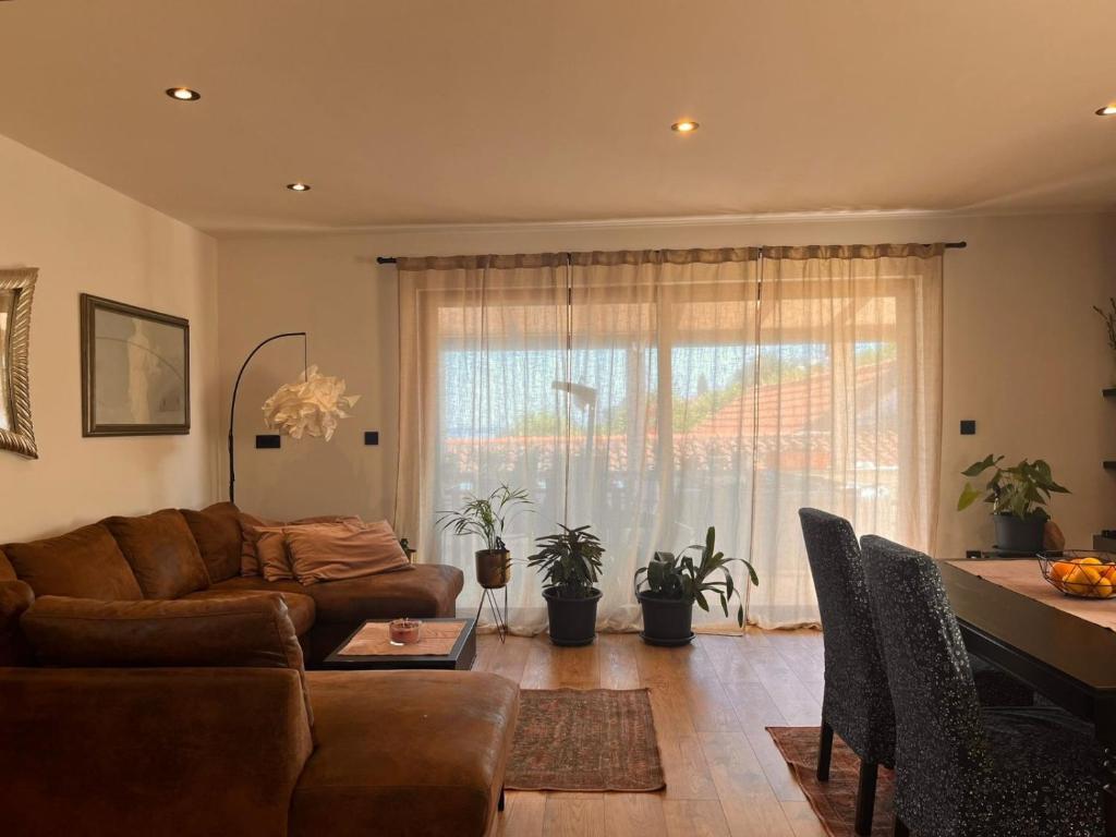 a living room with a couch and a table at Apartman Jesenjin Pobri in Volosko