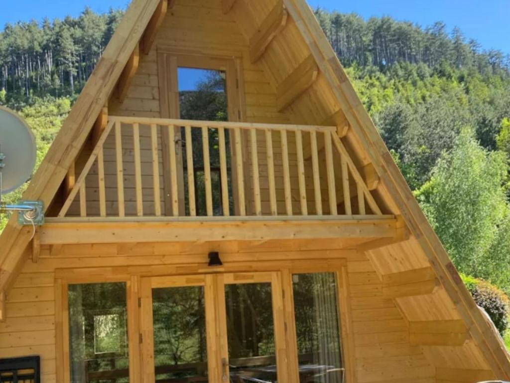 a view of a cabin with a deck at Cabane spacieuse - 7 pers. - API-1-52-2440 in Meyrueis