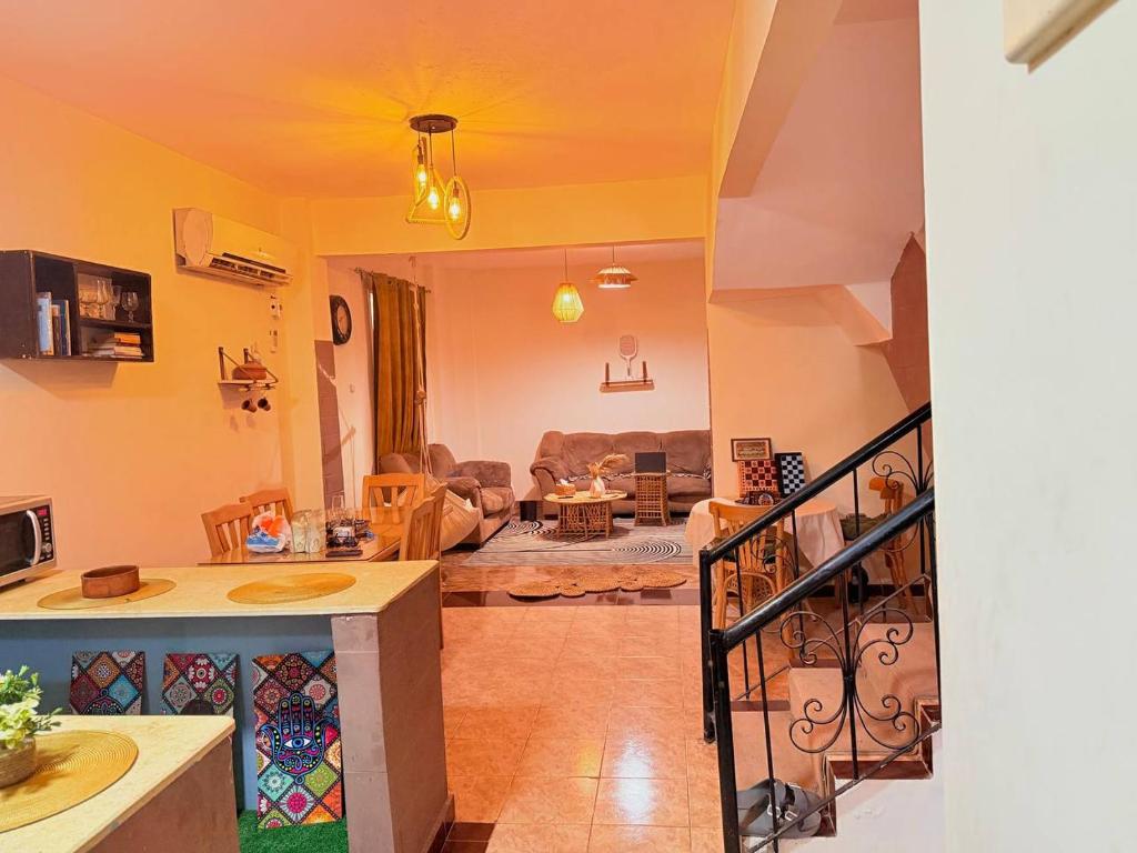 a living room with a couch and a table at Villa in a compound with a rooftop in sheikh zayed in Sheikh Zayed