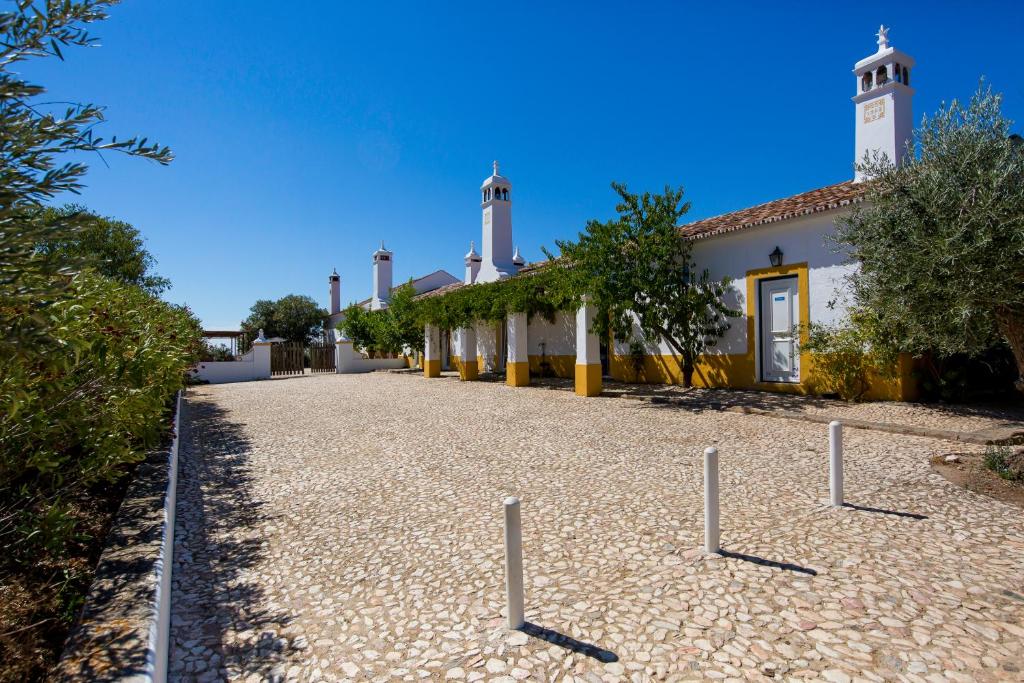 a building with a clock tower in front of it at Monte da Japonica in Redondo