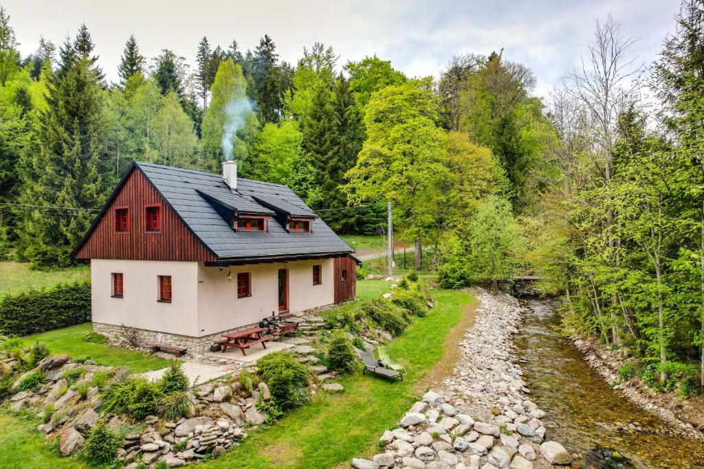 a house on a hill with a stream next to it at Jezinka Dolní Morava in Dolní Morava