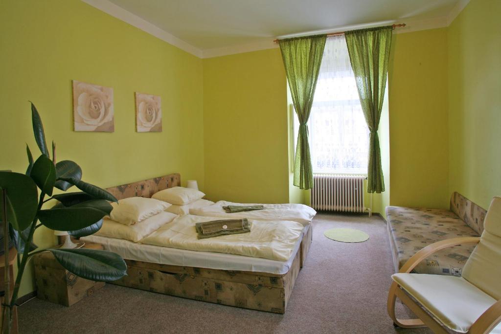 a bedroom with a bed and a window at Hotel Zlaty Jelen in Horažďovice