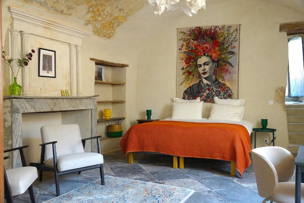 a bedroom with a bed with a painting on the wall at Ancienne eglise in Vallérargues