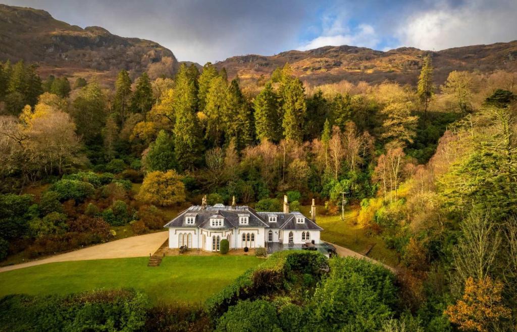 an aerial view of a house on a green field at Stuckgowan in Arrochar