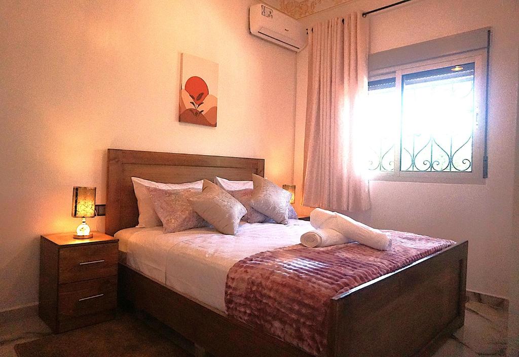a bedroom with a large bed with a window at Bab Akchour in Chefchaouen