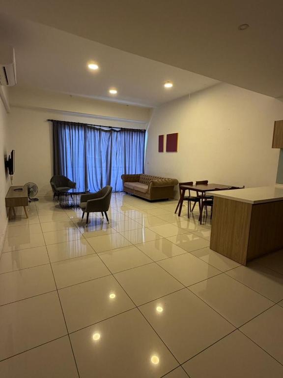 a living room with a couch and tables and chairs at aloha homestay in Miri