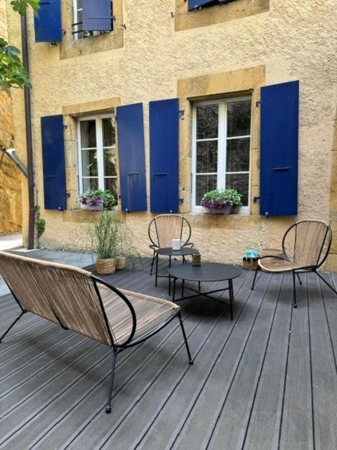 two chairs and a table on a wooden deck at Hôtel de l'Ecluse in Neuchâtel