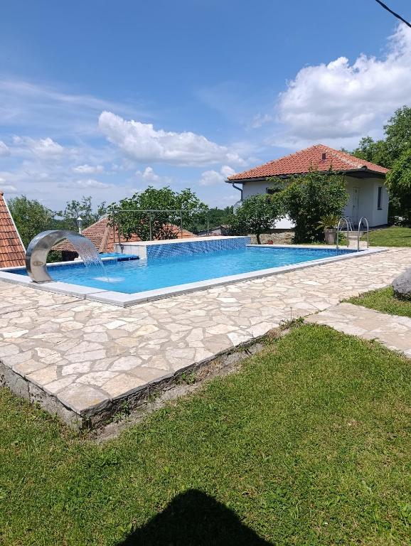 a swimming pool in the yard of a house at Apartman Petrovic in Rudnik