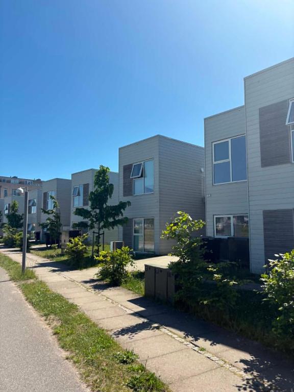 a row of apartment buildings on the side of a street at South Harbour Studios in Vordingborg