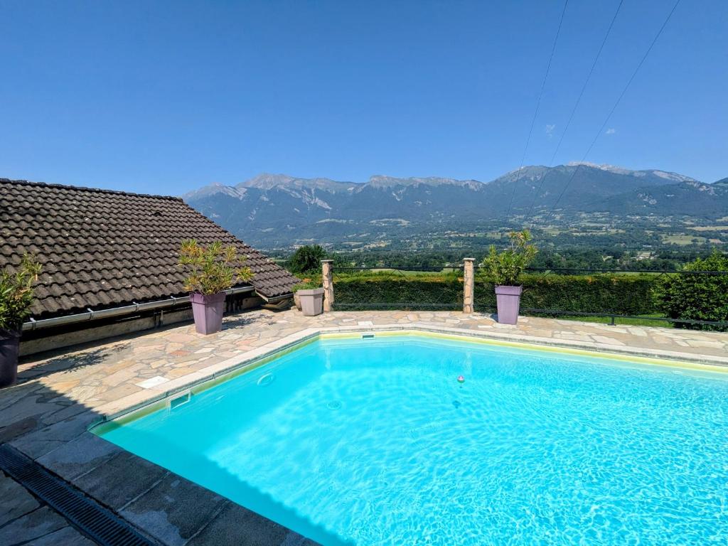 a swimming pool with a view of the mountains at Chalet romantique avec piscine in Monthion