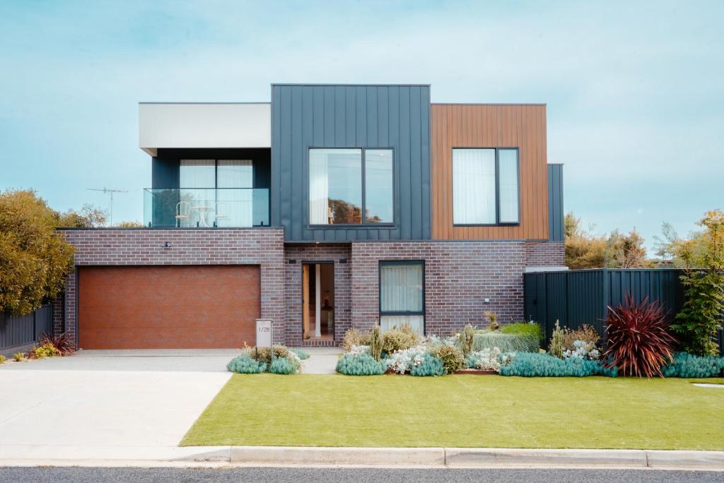 a brick house with a garage at Coastal on Clarke in Portarlington
