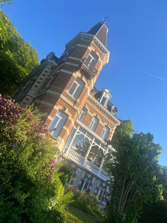 a large building with a turret on top of it at Chez Léopold II in Verviers