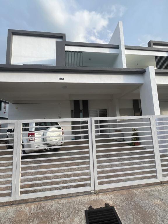 a car parked in front of a house at Exclusive Changlun Room in Bukit Kayu Hitam