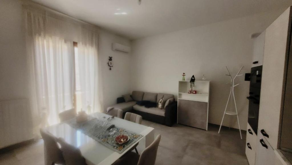 a living room with a couch and a table at L'Officina in Leverano
