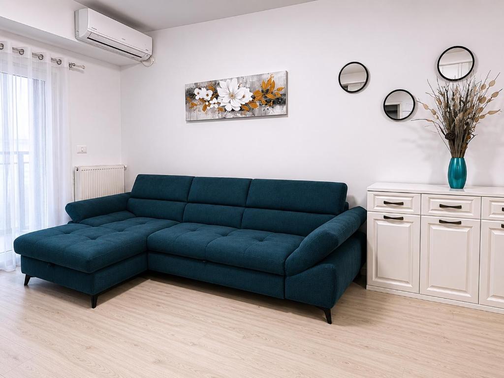 a blue couch sitting in a living room at Eqinox apartments in Mamaia Sat/Năvodari