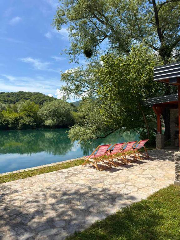 a group of chairs sitting next to a lake at Villa Una Bellevue in Bihać