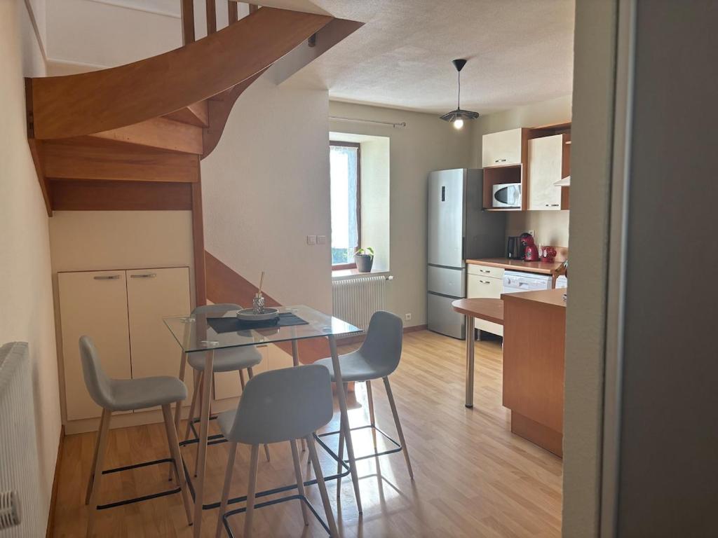 a kitchen with a table and chairs in a kitchen at Appartement - Baume-les-Dames in Baume-les-Dames