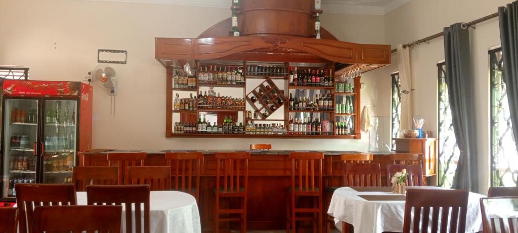 a restaurant with tables and chairs and a bar at Kagera Breeze Resort in Mbarara