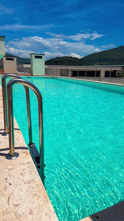 a large swimming pool with blue water at NOIR Luxury in Trebinje