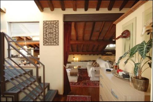 a room with a staircase and a living room at La Casina dei Piccioni in Lucca