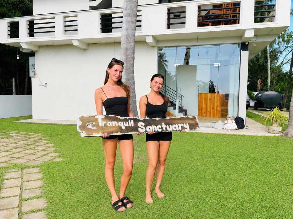 two women in bathing suits standing in front of a house at Tranquil Sanctuary Yala in Tissamaharama