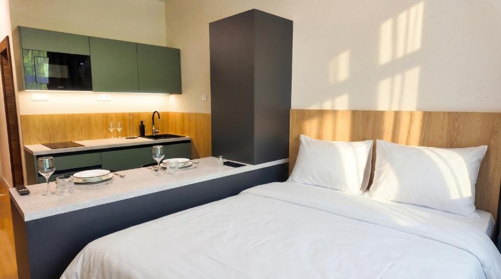 a bedroom with a bed and a counter with a sink at Axiom Suites - Nova 3 in KoÅ¡ickÃ© KÃºpele