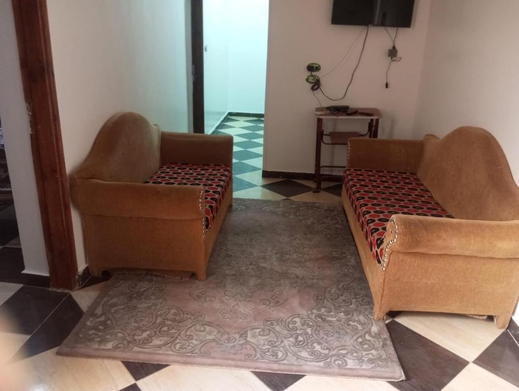 two chairs and a couch in a living room at Winjee in Abu Simbel
