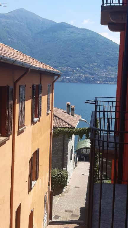 an alley with buildings and a view of the water at Lakeview Casa Camelia 21 in Acquaseria