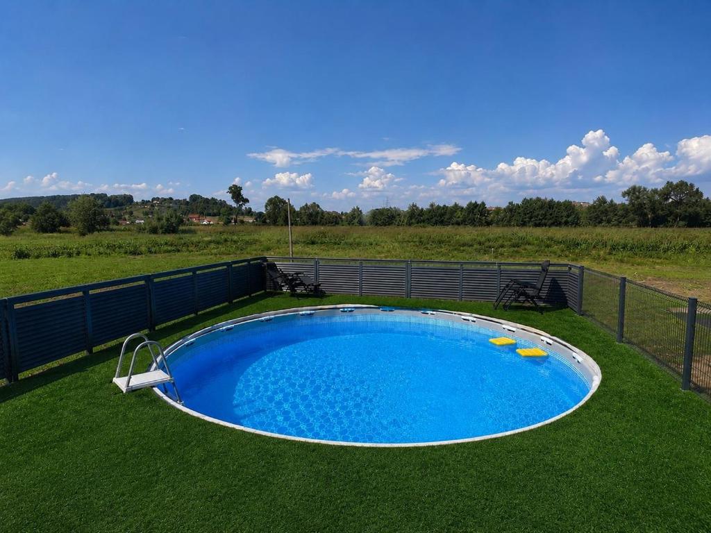 a large swimming pool in the middle of a field at Vikendica Mavi in Gradačac