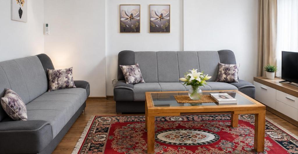 a living room with a couch and a coffee table at Rose Apartment in Jajce