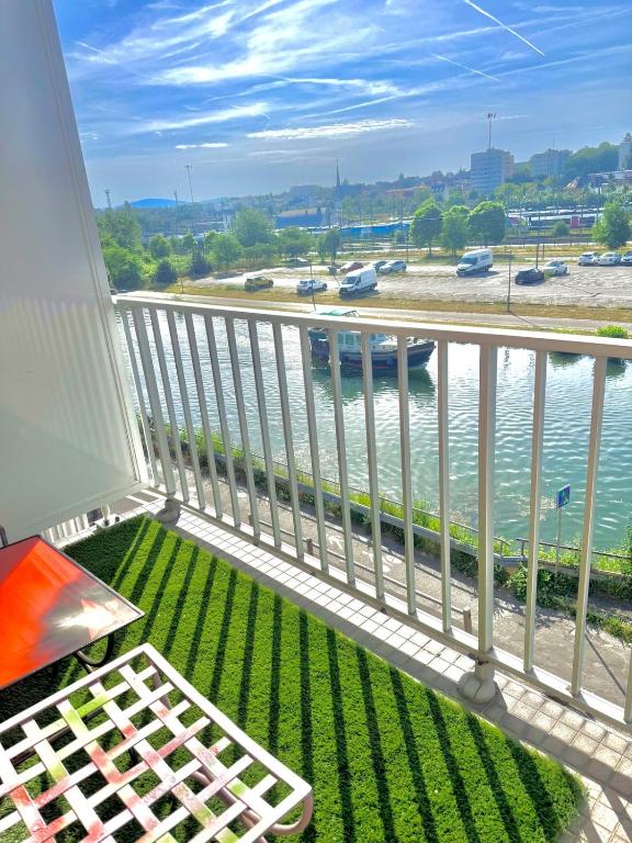 a balcony with a view of the water at La Résidence Urbaine in Mulhouse