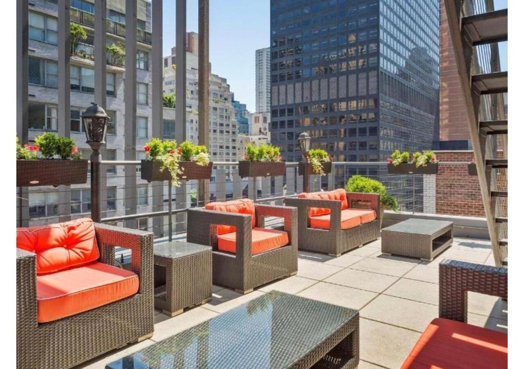 a balcony with chairs and tables on a building at The Historic Blue Angel Hotel Lexington Ave, an Ascend Collection in New York