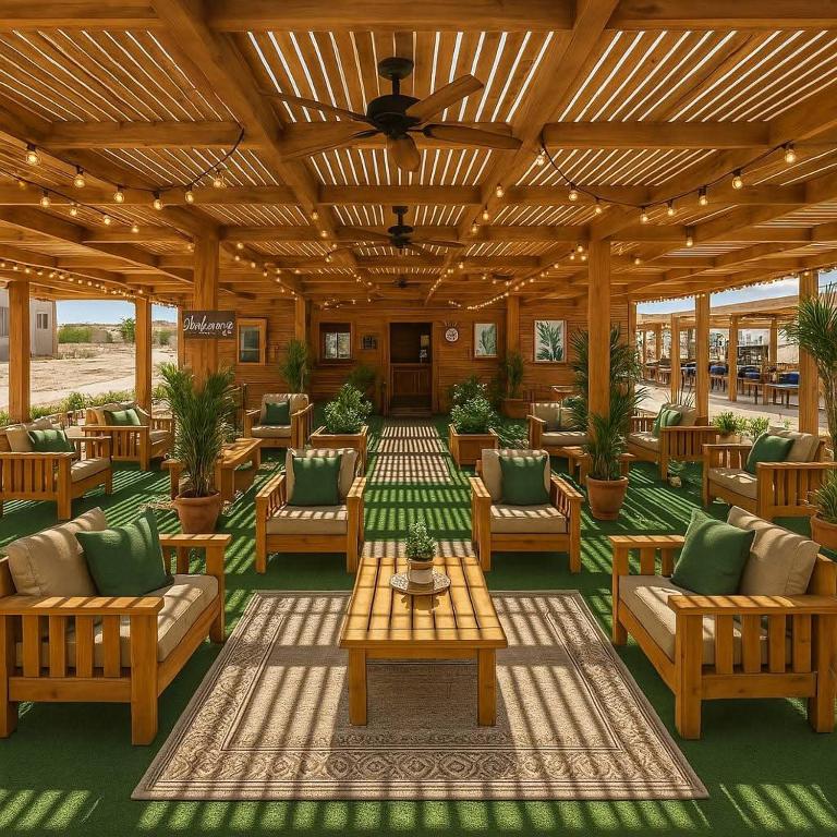 a large outdoor patio with chairs and tables at Halaشاليه in Ras Sedr