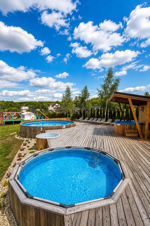 a pool on a wooden deck with two swimming pools at Osada Solina in Solina