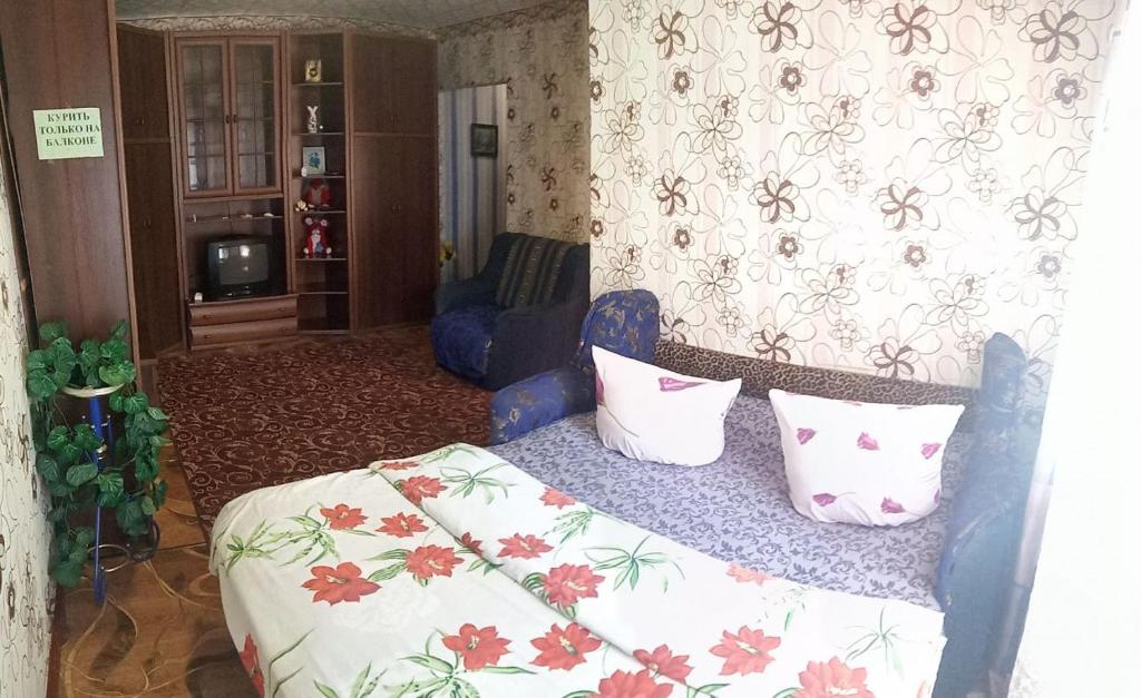 a bedroom with a bed with pillows on it at Квартира in Konotop