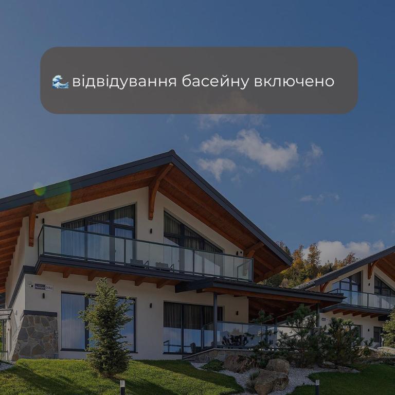 a house with a balcony in front of it at Chalet 348 in Palyanytsya